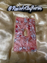 a pink and silver light switch cover