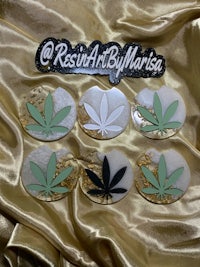 four marijuana leaves on a gold background