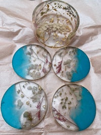 four glass coasters with flowers on them